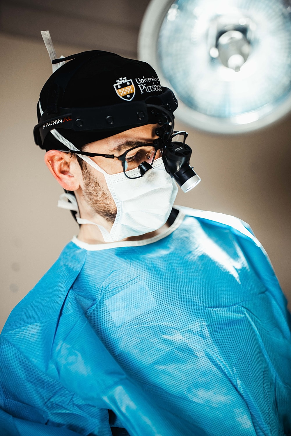 Surgeon preparing for a procedure in operating room.