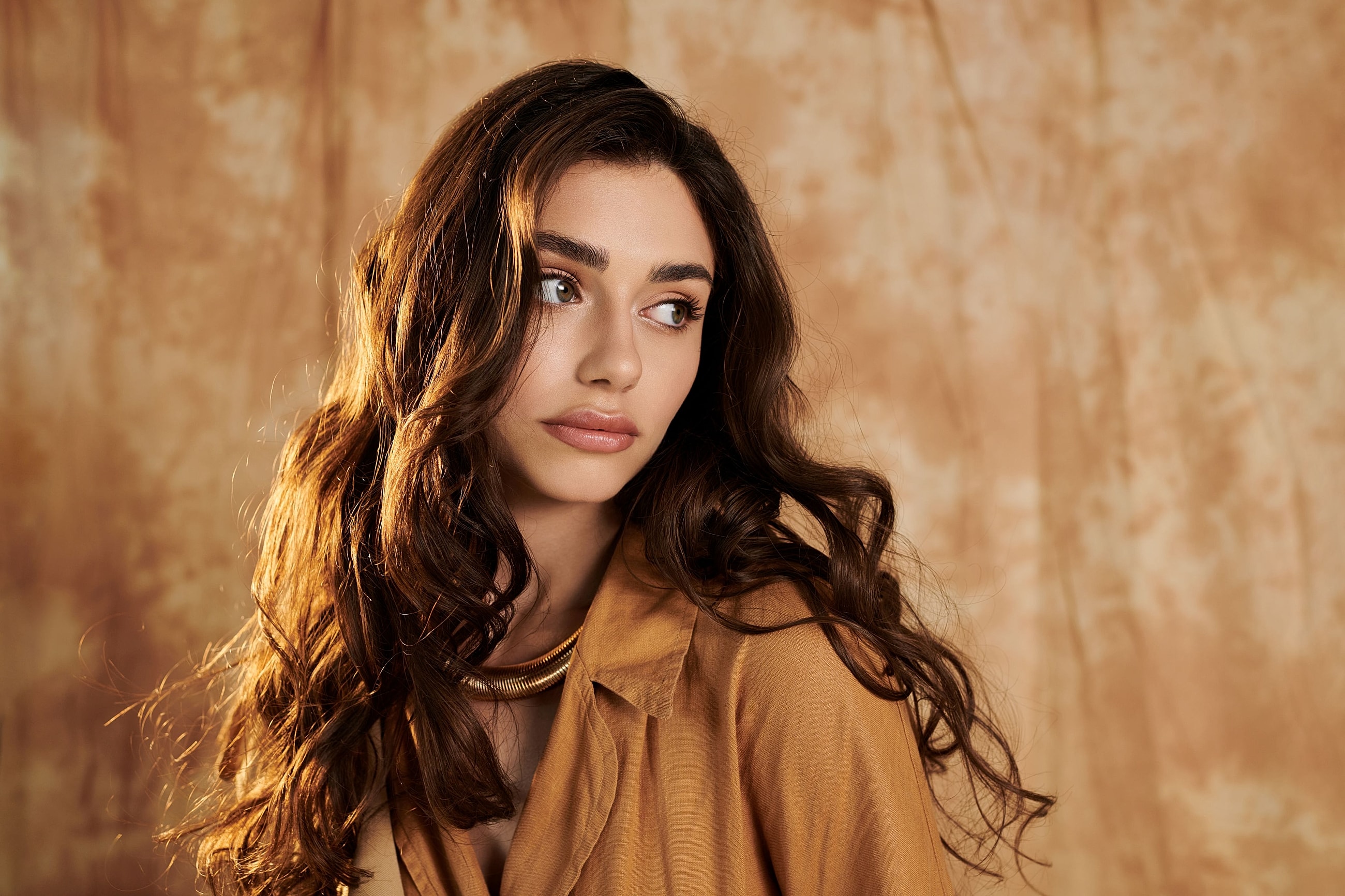 Woman with long dark hair and defined facial contours, illustrating facial rejuvenation options after major weight loss.