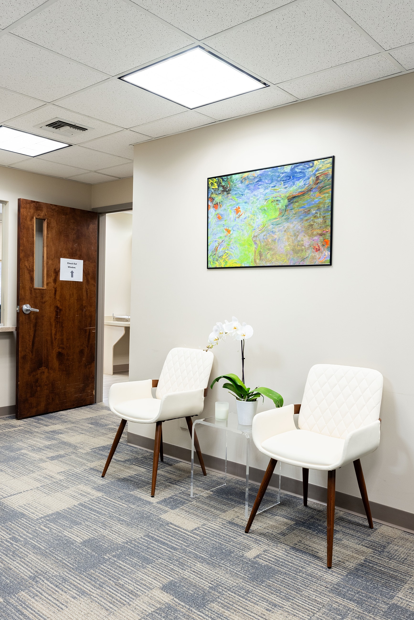 Waiting area with chairs and artwork on wall