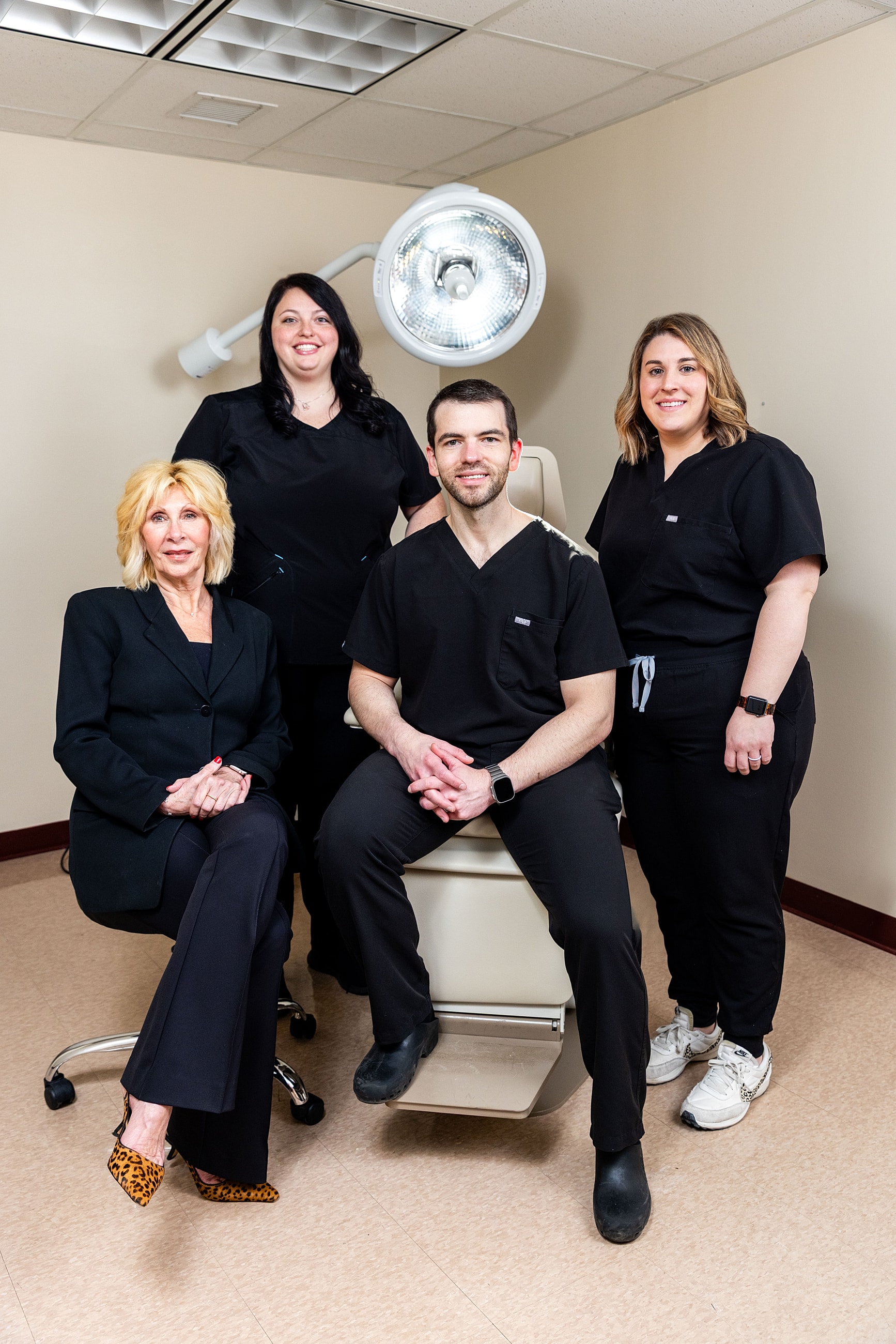 Medical team posing in clinic setting.
